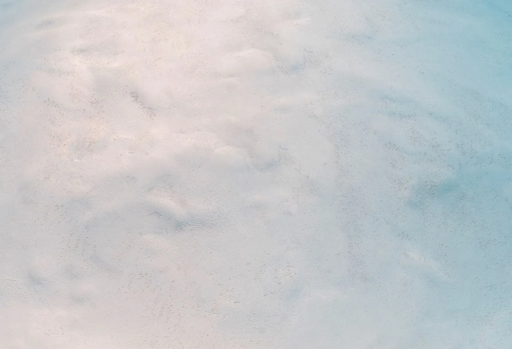 Detail of rustic white plaster wall at Pecan Square Cafe in Austin.