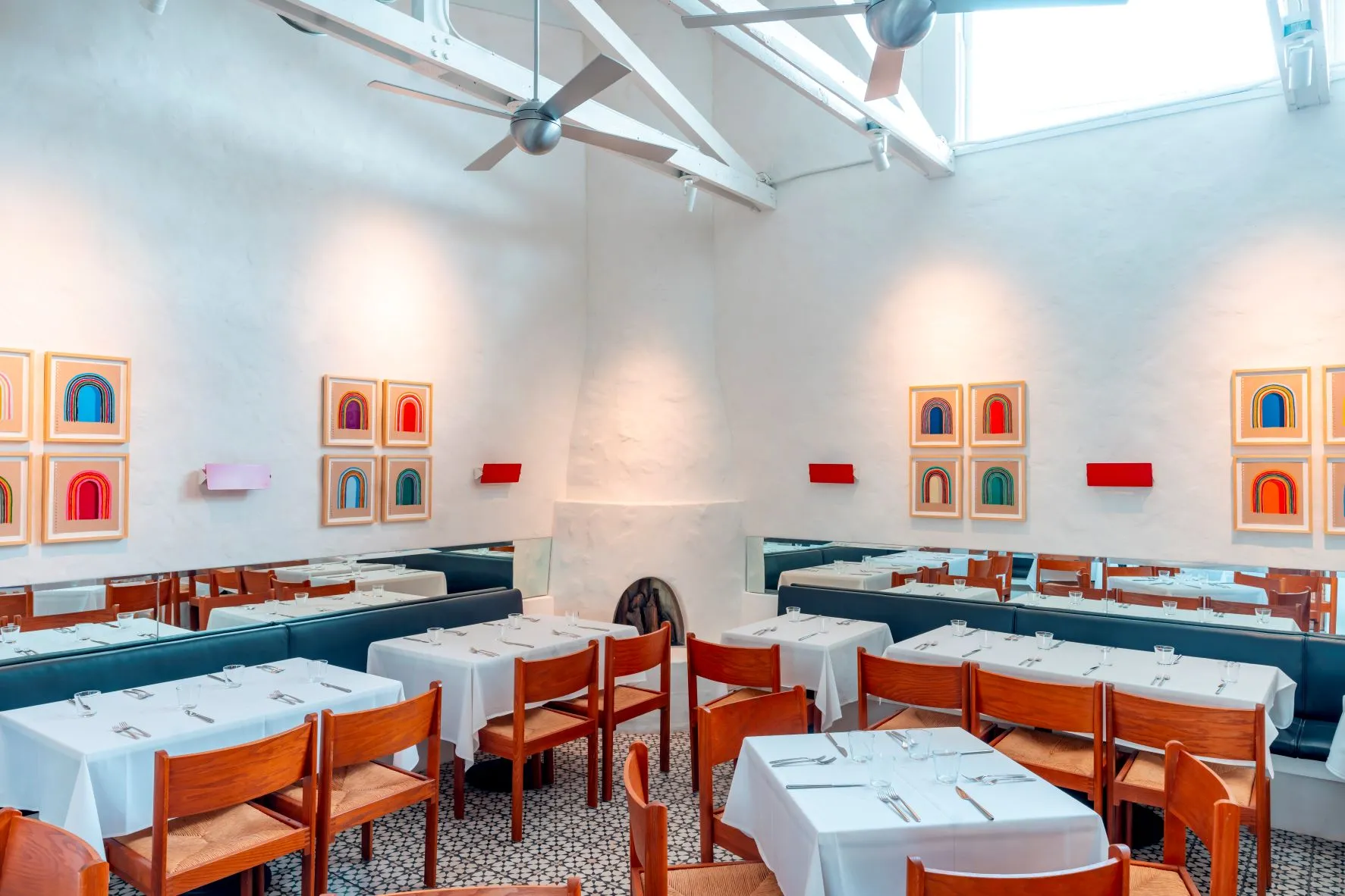 Textured white plaster walls join Matt Kleberg's modernist drawings at Pecan Square Cafe.