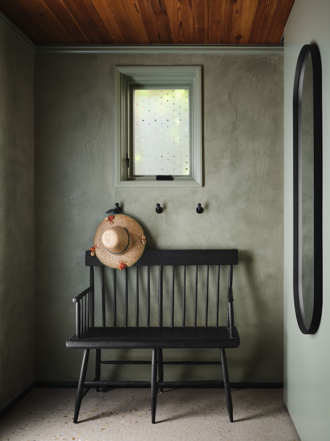 Sage green plaster walls add charm and personality in an 1870s San Antonio home designed by Lake Flato.