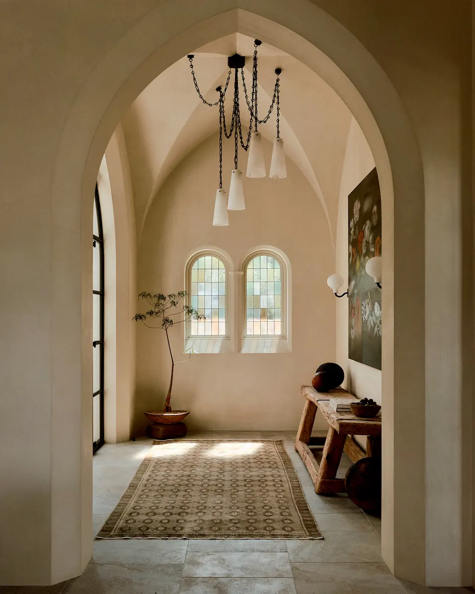 Smooth lime plaster adorns a sculptural vaulted ceiling and frames delicate stained glass windows in a stunning new Austin, Texas home.